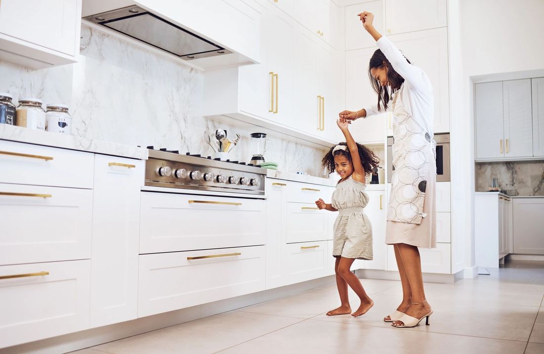 Family in a bright, modern white kitchen